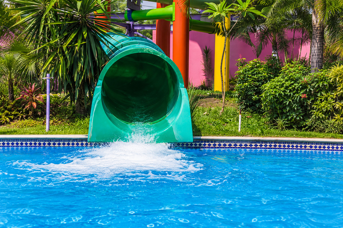 A green water slide opening into a blue pool at Ex Hacienda de Temixco, Morelos.